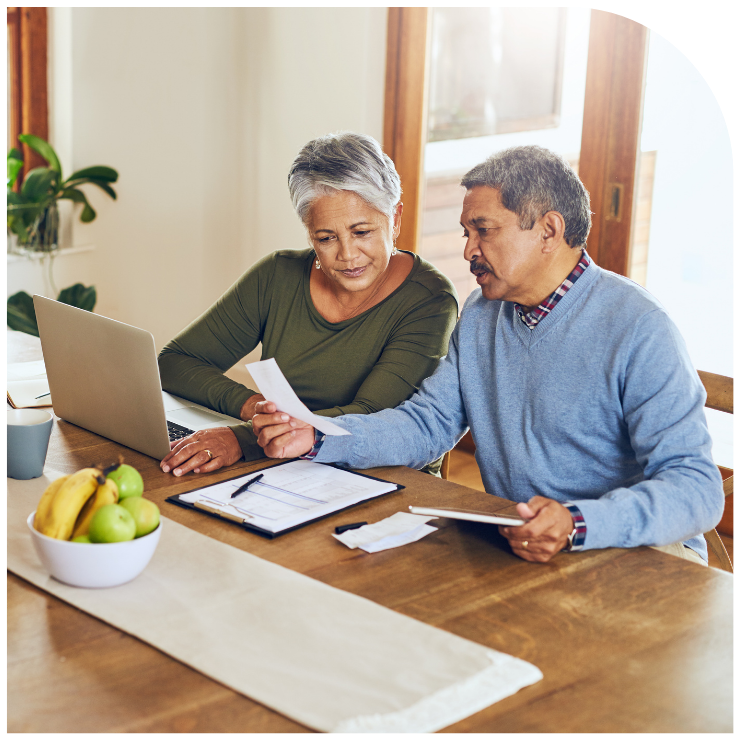 older couple at computer with paperwork